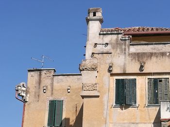 Low angle view of bell tower against blue sky