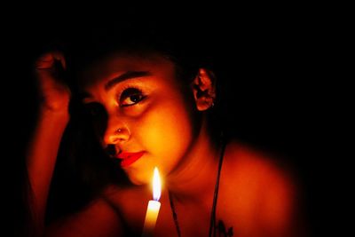 Close-up portrait of mid adult man in darkroom