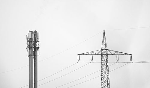 Low angle view of communications tower against sky