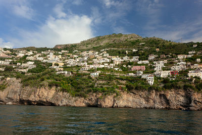 Town by sea against sky