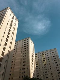 Low angle view of modern buildings against blue sky