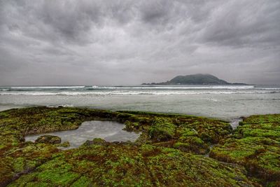 Scenic view of sea against cloudy sky