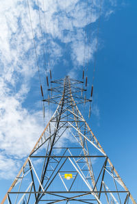 Low angle view of electricity pylon against sky