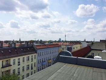 Buildings against cloudy sky
