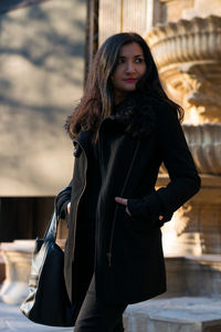 Woman wearing winter coat walking on street