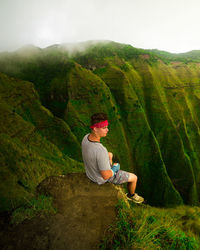 Man looking at mountain range against sky