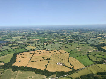 Aerial view of agricultural field against clear sky