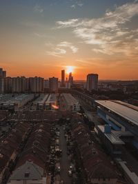 High angle view of buildings against sky during sunset