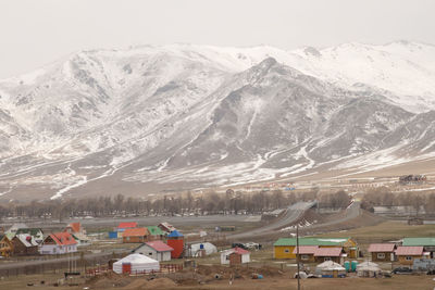 Aerial view of townscape and snowcapped mountains