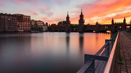 View of buildings at waterfront during sunset