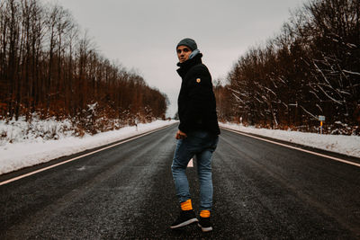 Full length of man walking on road during winter