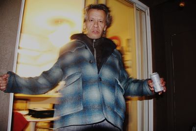 Portrait of man standing against doorway