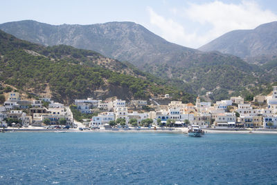 Scenic view of sea and mountains against sky