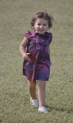 Portrait of a girl standing on field