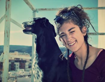 Close-up of smiling young woman with horse