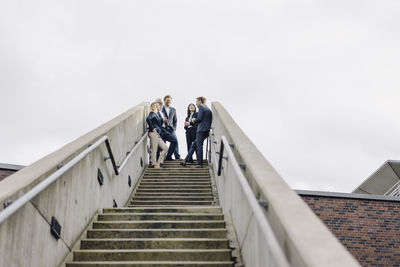 Business people standing on exterior stair