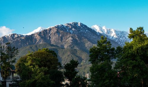 Scenic view of snowcapped mountains against clear sky