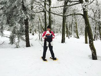 Woman standing on snow covered landscape