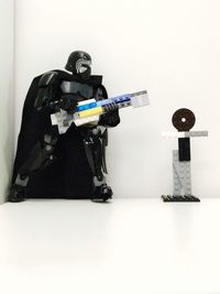 Man holding camera on table against white background