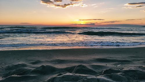 Scenic view of beach against sky during sunset