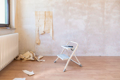 Chair on table against wall at home