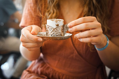 Girl holding a cup of coffee