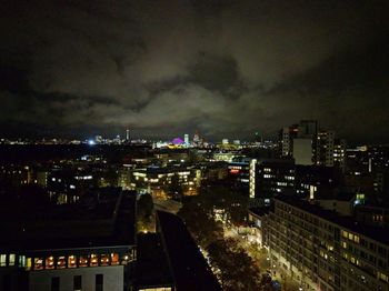 High angle view of illuminated cityscape against sky at night