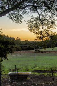 Scenic view of field against sky during sunset