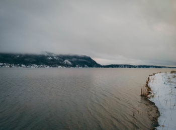 Scenic view of sea against sky during winter