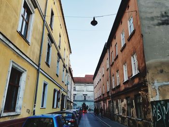 Cars on street amidst buildings in city