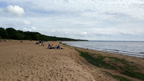 People on beach against sky