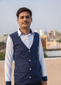 Portrait of man standing against sky
