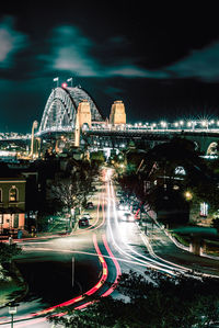 Light trails on city street against sky at night