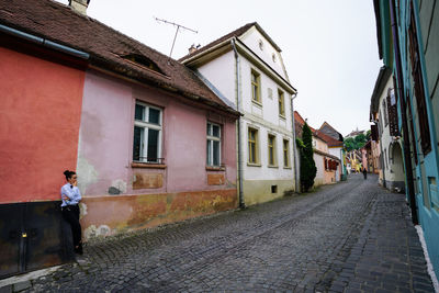 Street amidst buildings in town against sky