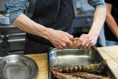 Midsection of man preparing food