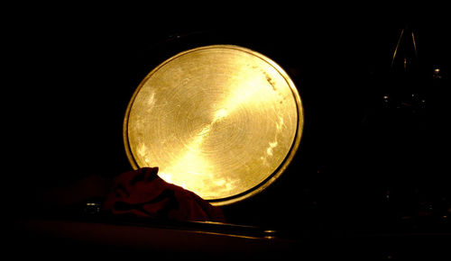 Close-up of illuminated lamp against black background