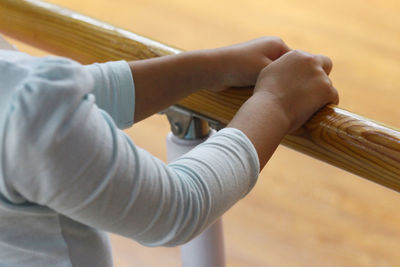 Midsection of woman by wooden railing