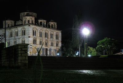 Low angle view of building lit up at night