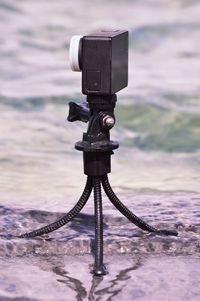 Close-up of camera on sea against sky