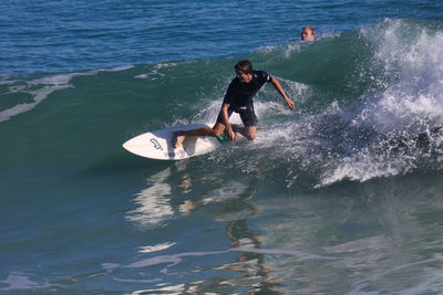 Full length of man surfing in sea