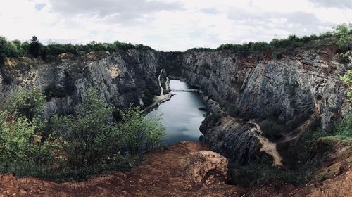 Lake amidst rock formation against sky