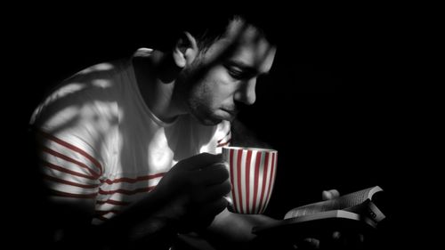 Close-up of hands over black background