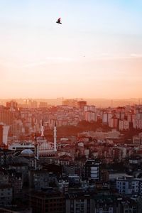 High angle view of buildings in city against sky during sunset