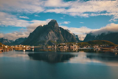 Scenic view of lake by mountains against sky