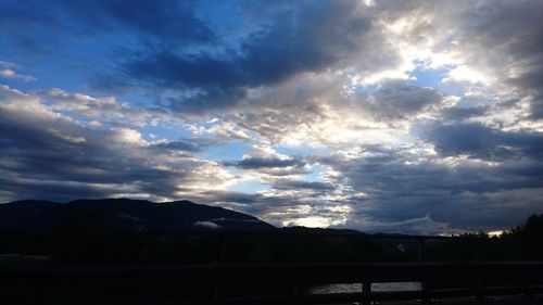 Scenic view of mountains against cloudy sky