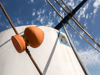 Low angle view of electric lamp against sky