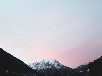 Scenic view of snowcapped mountains against sky during sunset