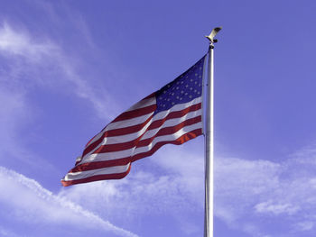 Low angle view of flag against blue sky