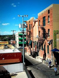 Street and buildings against blue sky