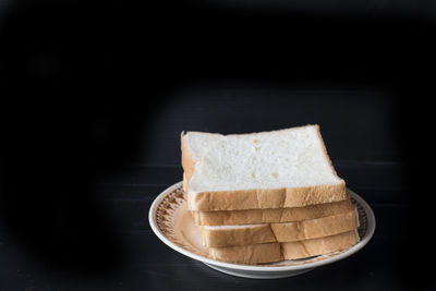 Close-up of breakfast on table against black background